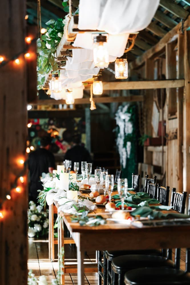 The bridal party's head table dressed with flowers and candles.