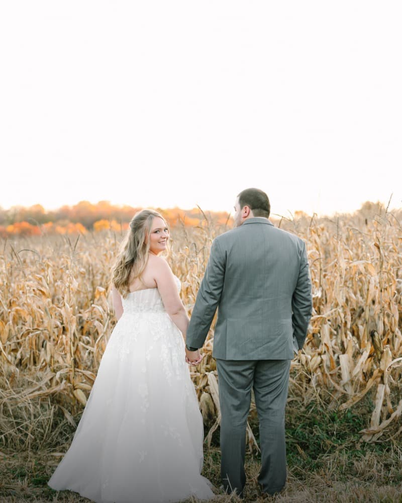 The couple standing in the corn field on the property.