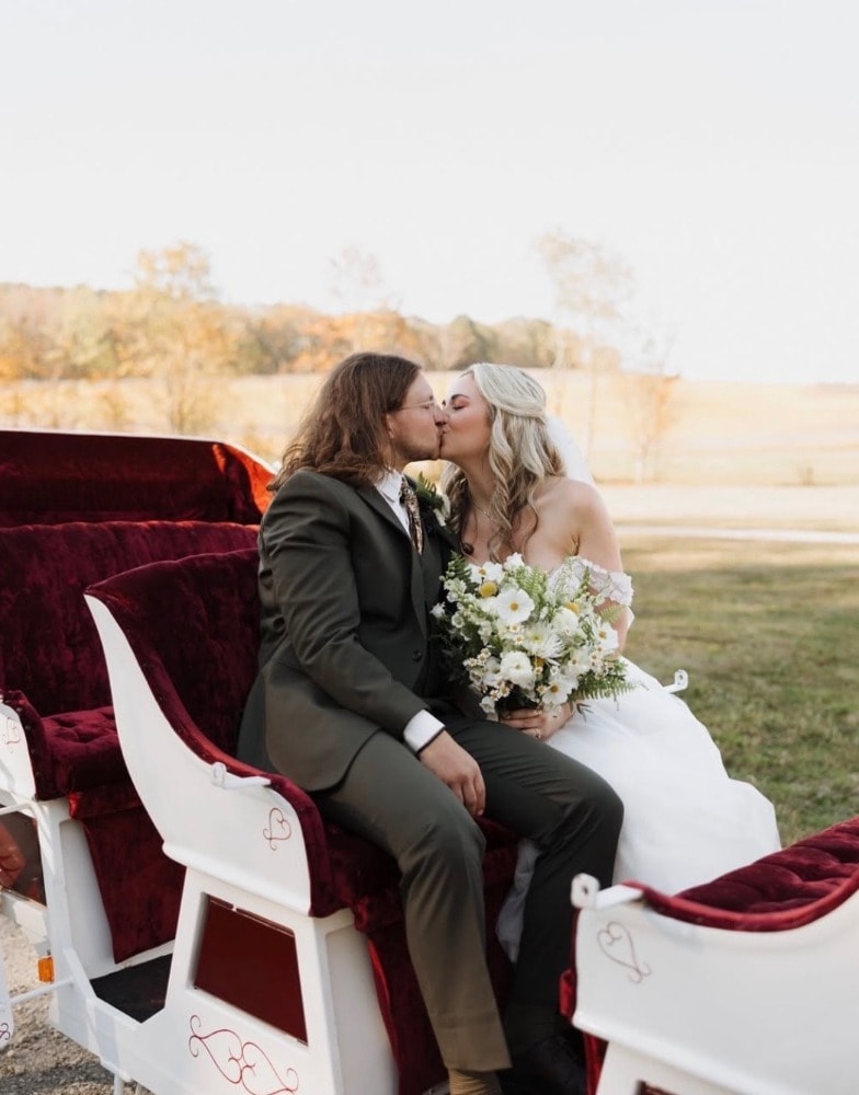 The couple riding a horse-drawn carriage on the property.
