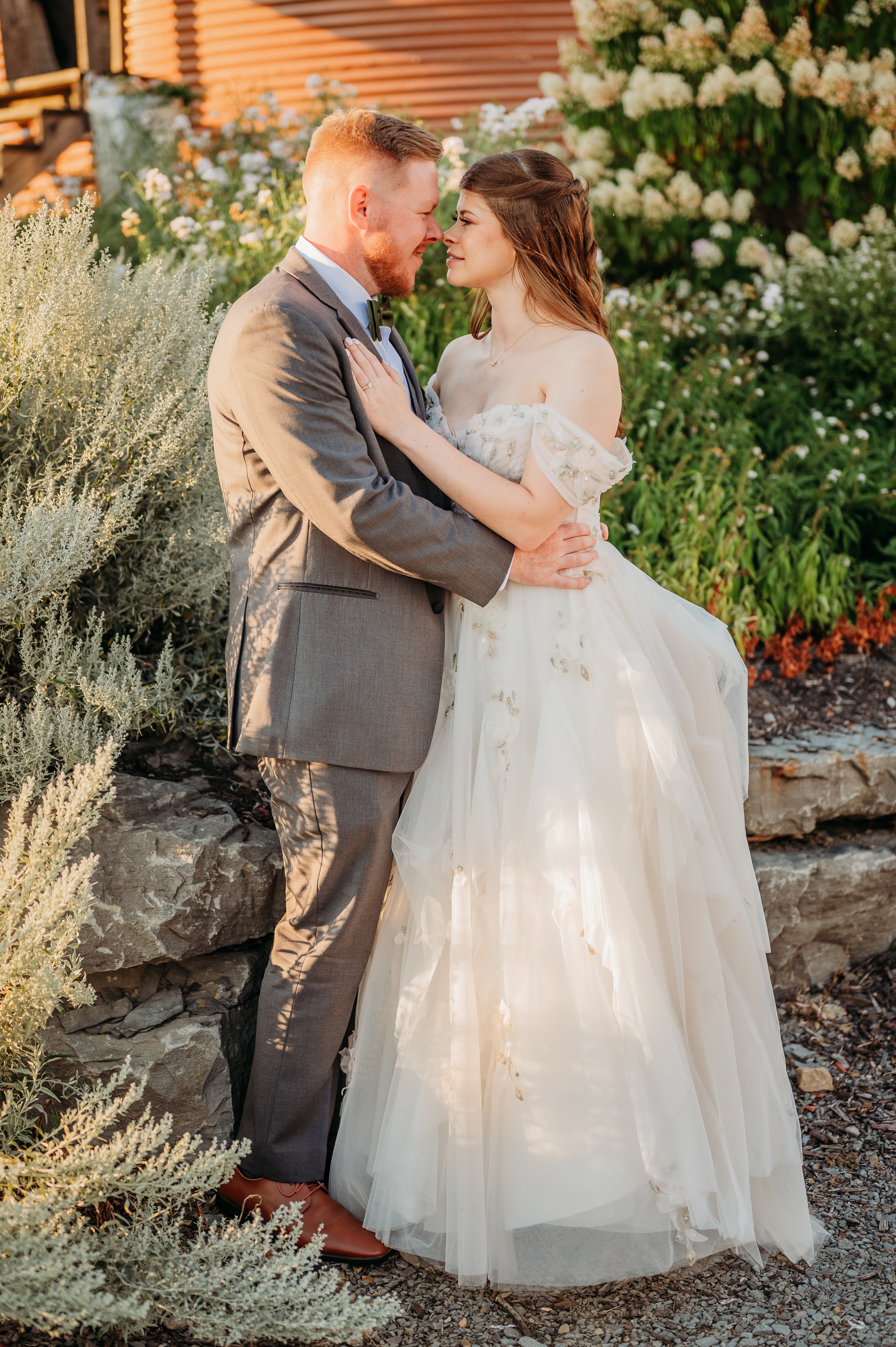 The couple outside the barn on the farm.